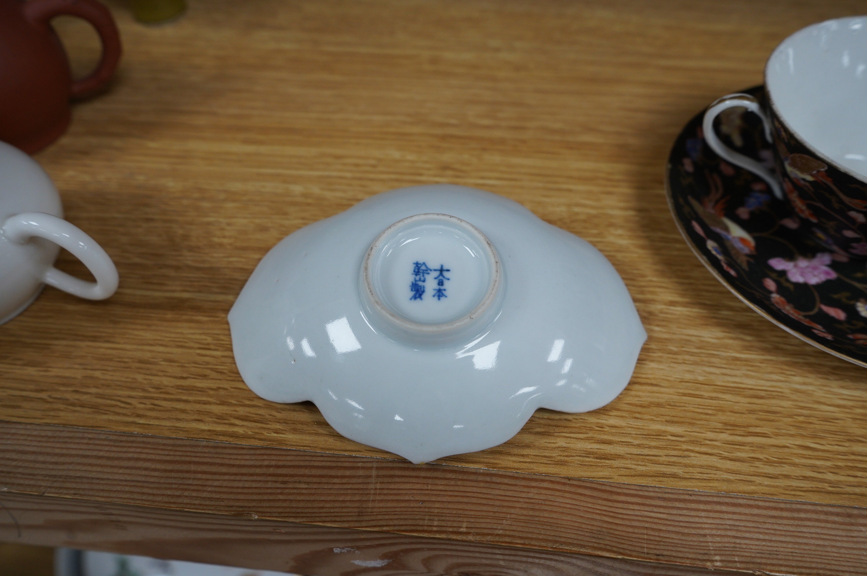 A group of Chinese and Japanese ceramics to include Yixing teapots, porcelain cups and saucers, a blue and white vase and a tiger talisman. Condition - mostly good